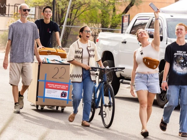 a group of people walking with their belongings into a building